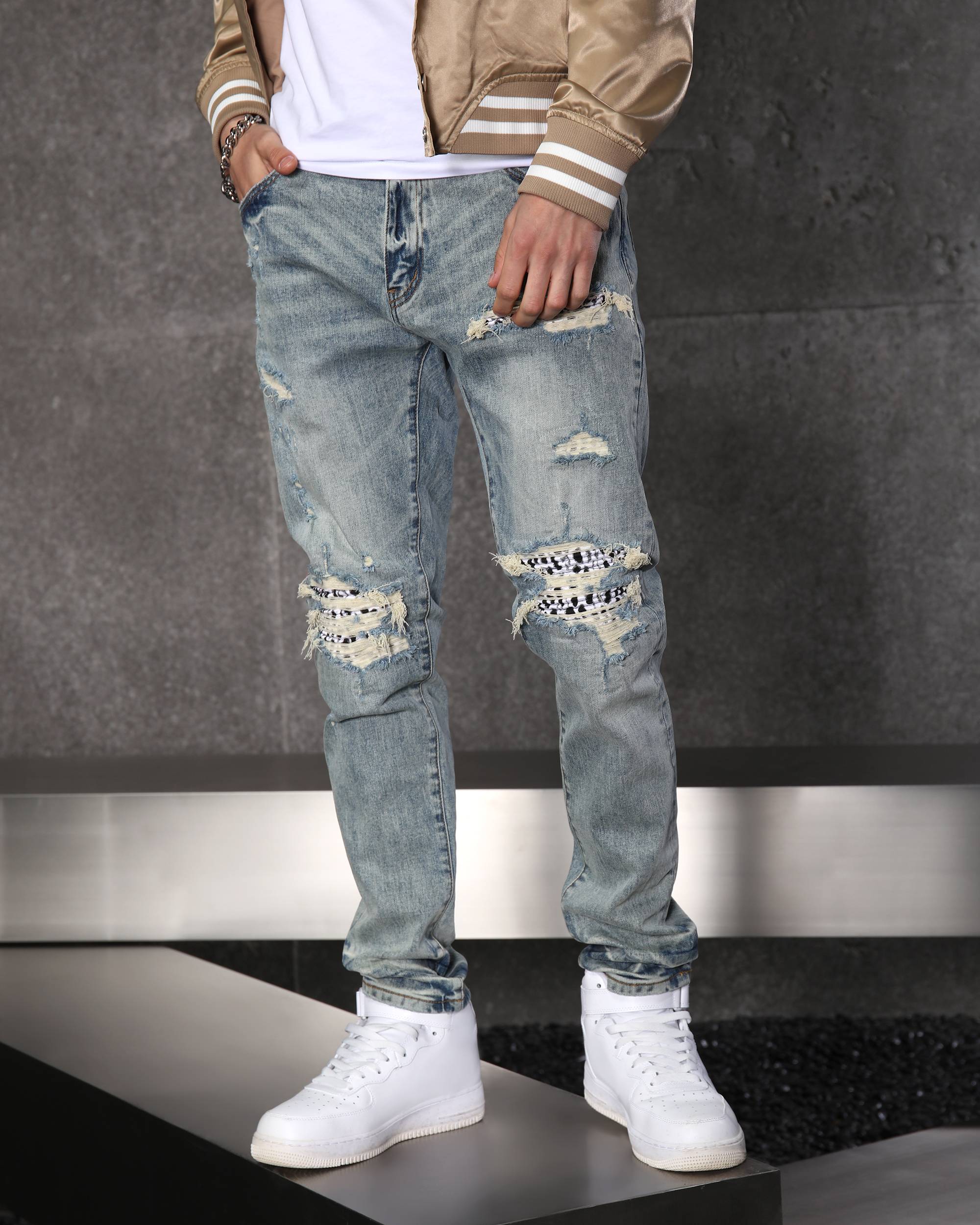 Unique Men’s Light Blue Ripped Jeans with Checkered Patches
