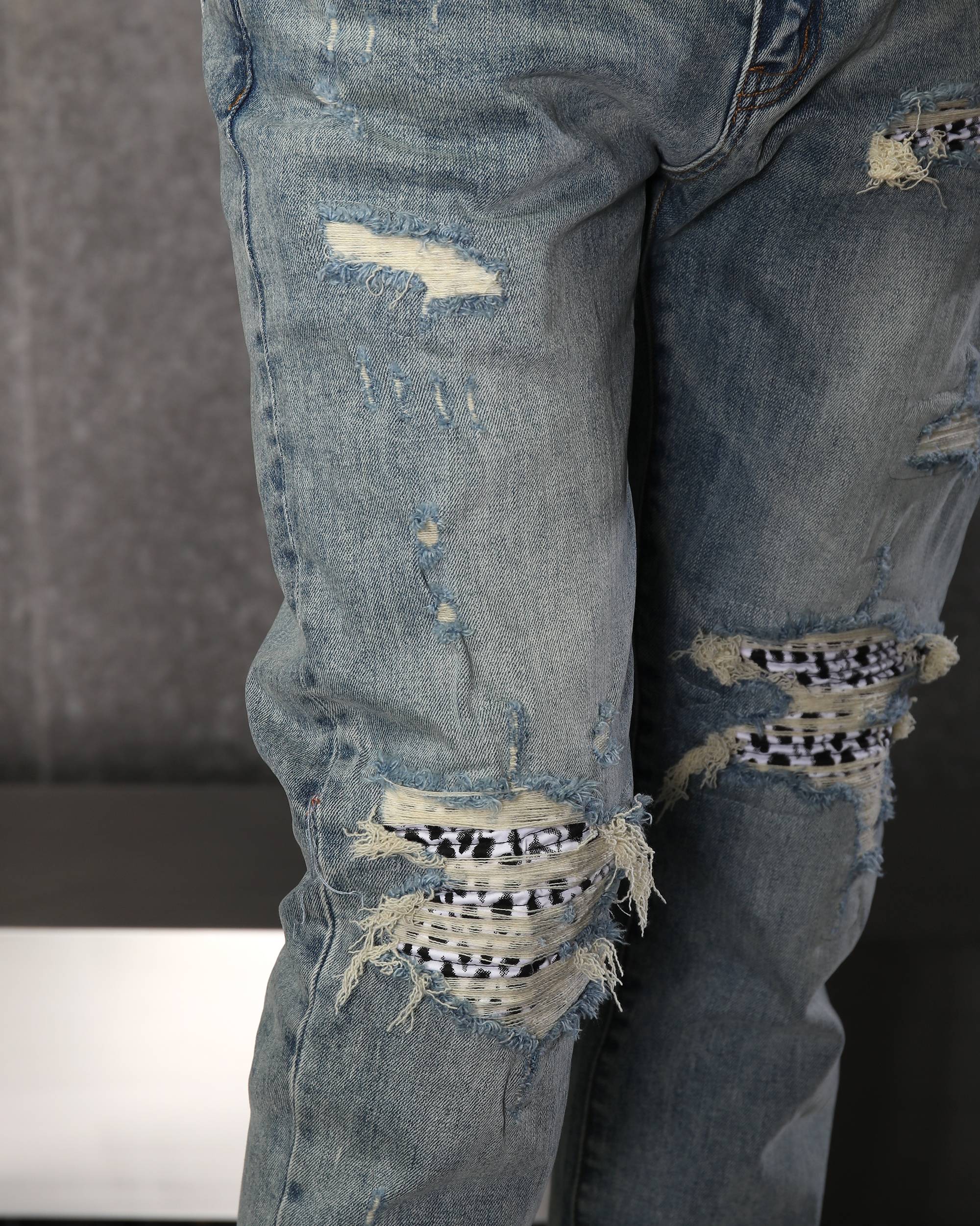 Unique Men’s Light Blue Ripped Jeans with Checkered Patches