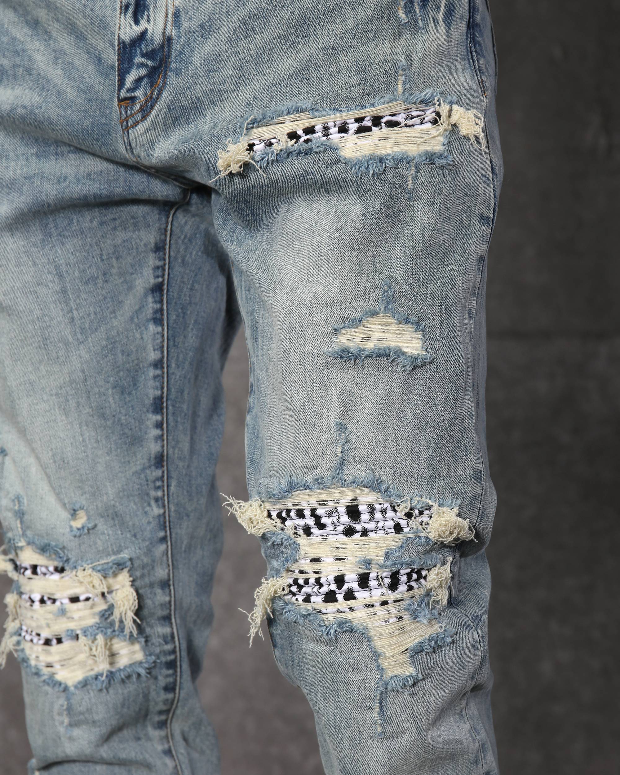 Unique Men’s Light Blue Ripped Jeans with Checkered Patches